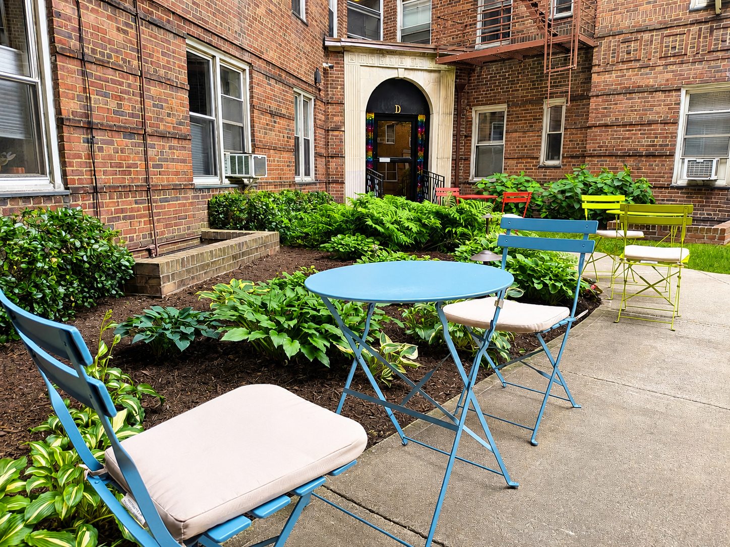 Colorful tables and chairs among the Washington Plaza courtyard plantings